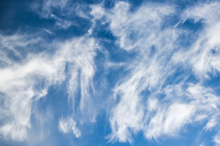 White spindrift clouds on blue sky, backgroundの写真素材