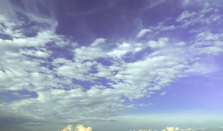 White spindrift clouds on blue sky, background