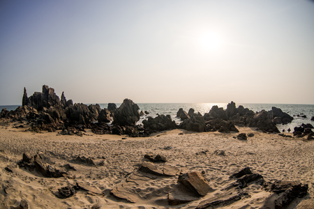Beauty rocky beach in sunny day with clean meadow skyの写真素材