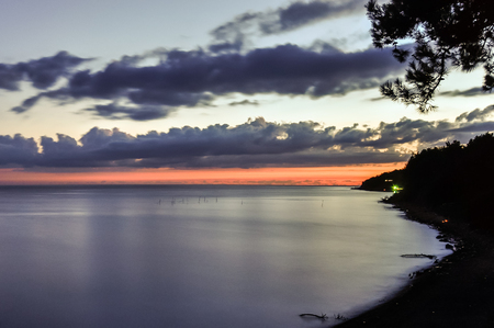 Scenic colorful sunset over sea coast lineの写真素材