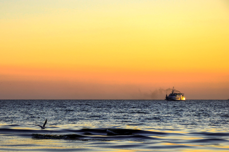 Bright sky and water at colorful sunset over sea landscapeの写真素材