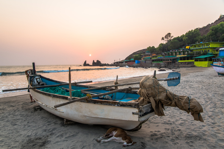 fishing boat on tropical beach at sunsetの写真素材
