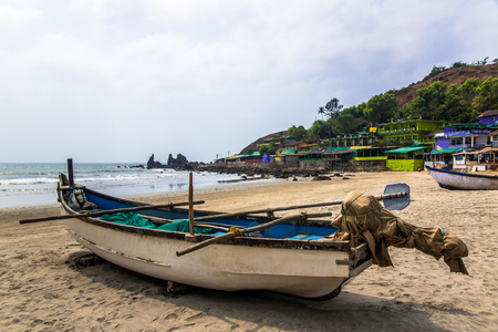 fishing boat on tropical sandy beach in sunny dayの写真素材