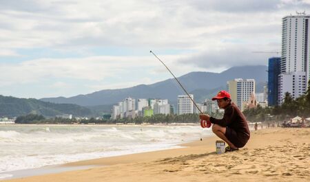 Old fisherman with Fishing pole on the sandy beachのeditorial素材