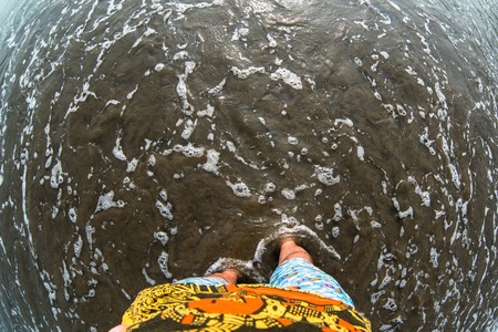 Man feet on sandy beach. fisheye effectの写真素材
