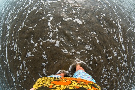 Man feet on sandy beach. fisheye effectの素材 [FY31099661314]