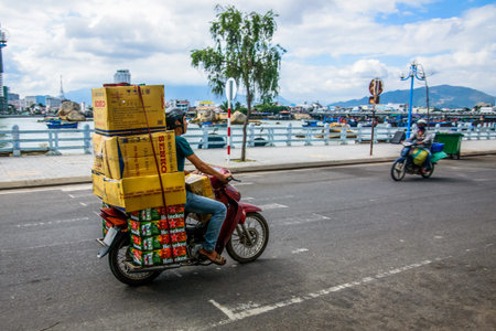 Vietnam, Nha Trang - January 8, 2016: Man with huge luggage on scooter