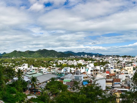 View of urban cityscape with mountain and river background in a sunny dayの写真素材