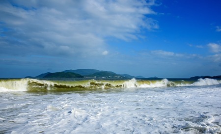 Panoramic view of a wild tropical beach with blue sky and cloudsの写真素材