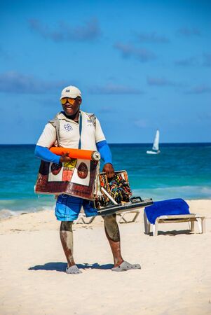 Punta Cana, Dominican Republic - September 16, 2014: souvenir seller on the beachのeditorial素材