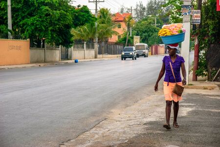 Punta Cana, Dominican Republic - September 17, 2014: Woman carries heavy load on headのeditorial素材