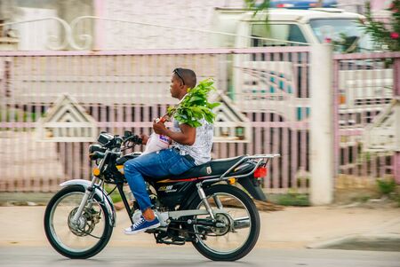 Punta Cana, Dominican Republic - September 17, 2014: Local men riding motorcycle on street of Punta Canaのeditorial素材