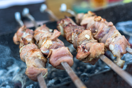 Shashlyk preparing on a barbecue grill over charcoalの写真素材