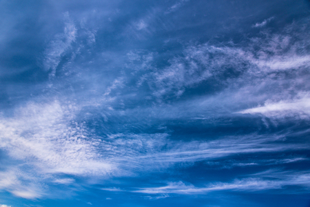 Blue sky with white abstract spindrift cloudsの写真素材