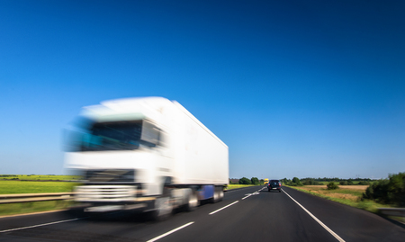 White delivery truck on highway with blurred effectの写真素材