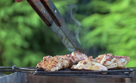 Shashlyk preparing on barbecue grill over charcoalの写真素材