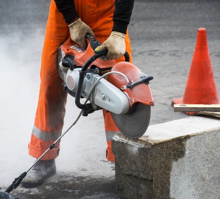 Circular saw machine is cutting concrete blockの写真素材