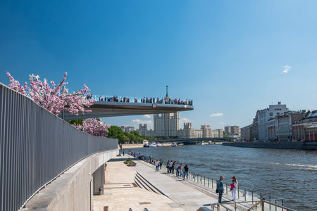 Moscow, Russia - May 13, 2018: People on a floating bridge in the landscape park Zariadye