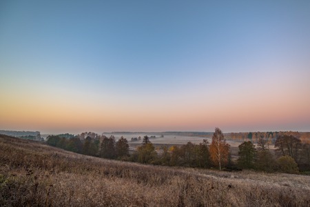 Misty fog in the morning country hill landscapeの写真素材