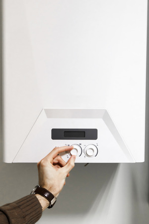man regulate heating boiler control panelの写真素材