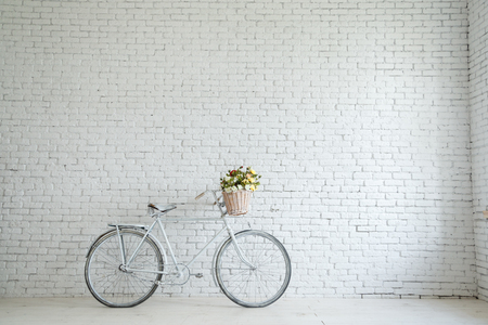 Retro bicycle on roadside with vintage brick wall background,の写真素材