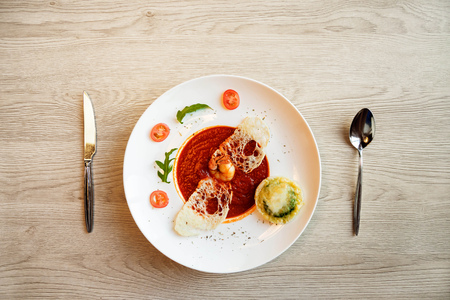 tomato soup on kitchen table. top shotの写真素材