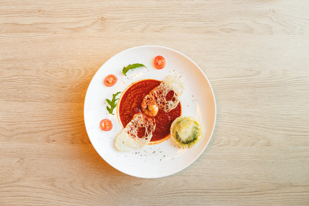 tomato soup on kitchen table. top shotの写真素材