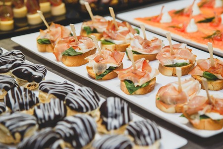 Tasty snacks with salted salmon and cottage cheese filling on plateの写真素材