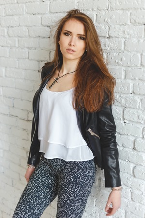 Portrait of sexy beautiful young brunette woman in leather jacketの写真素材