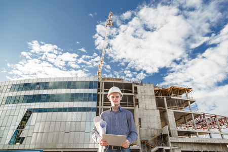 A foreman with digital tablet supervising the project at the construction.の写真素材