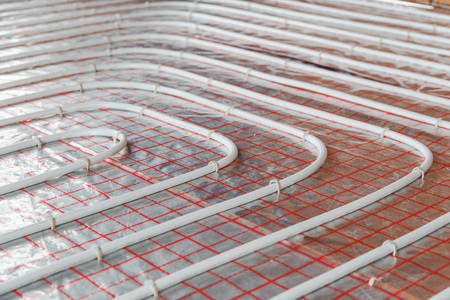 Underfloor heating installation. Close up on water floor heating system interior. plumbing pipes. Individual Heating.の写真素材