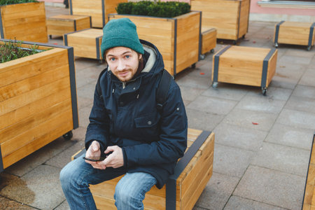 Tourist man try navigate himself with map and smartphone in unknown city
