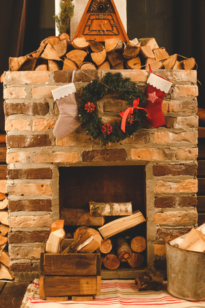 Christmas socks hanging on fireplace in roomの写真素材