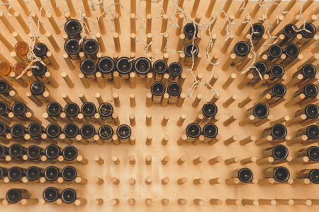 The bottles on the shelves of the wine cellar. Front view.の写真素材