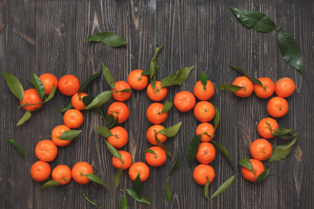 new year 2017 of tangerines on wooden background, card.