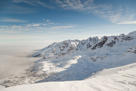 Mountain snow-capped peaks in bright sunny weather. A delightful winter landscape.の写真素材