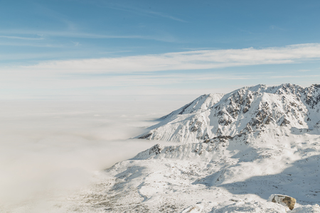 Spectacular winter landscape. Mountains surrounded by low cloudの写真素材