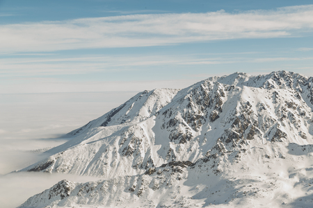 Wonderful winter landscape of mountains in the cloudsの写真素材