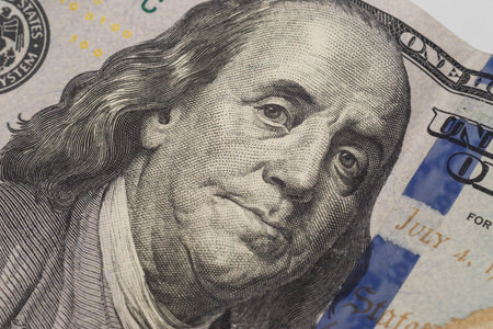 Dollars closeup. Benjamin Franklins portrait on new one hundred dollar banknote.