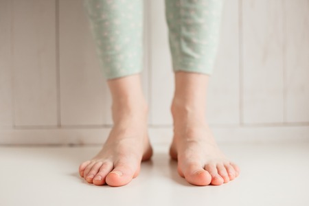 Bare feet of a girl tired of uncomfortable shoes, close-upの写真素材