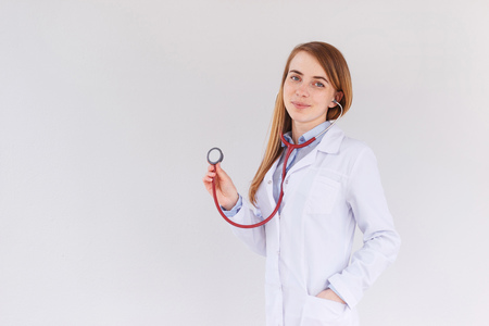 Portrait of female doctor using stethoscopeの写真素材