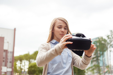 Modern technology vr headset in woman hands.の写真素材