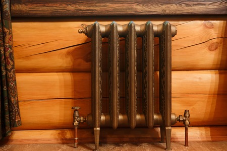 Cast iron retro design radiator in timber houseの写真素材