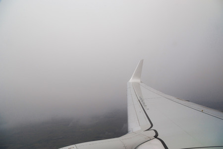 View from the window of the plane in bad non-flying weather. Turbulence in flight.の写真素材