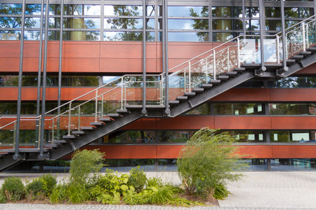 Fire escape staircase emergency exit on the background of the modern building facadeの写真素材