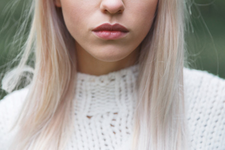 close-up portrait of beautiful model with natural make-up, shooted on blue backgroundの写真素材
