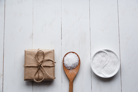 Healthy Sea Salt with giftbox on white wooden background. Flat lay. Copy spaceの写真素材