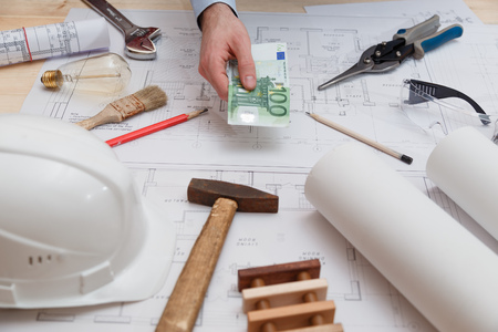 Man pays for engineering, construction and installation servicesの写真素材