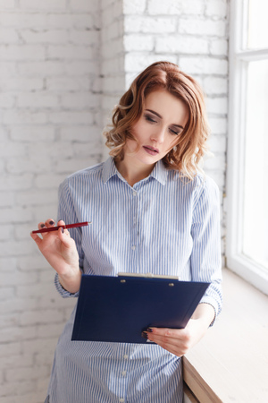 business woman with pen and folderの写真素材