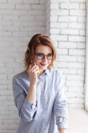 Elegant smiling business woman talking on the phoneの写真素材
